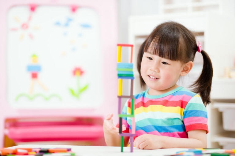 young girl play number sticks fine motor skill game for homeschooling